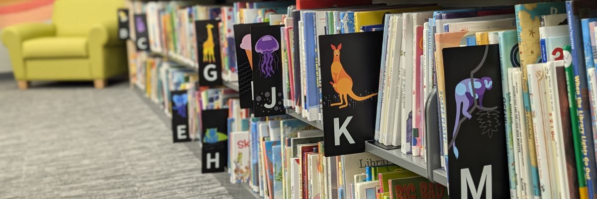 Angle view of children's shelving with colorful cards marking letter organization