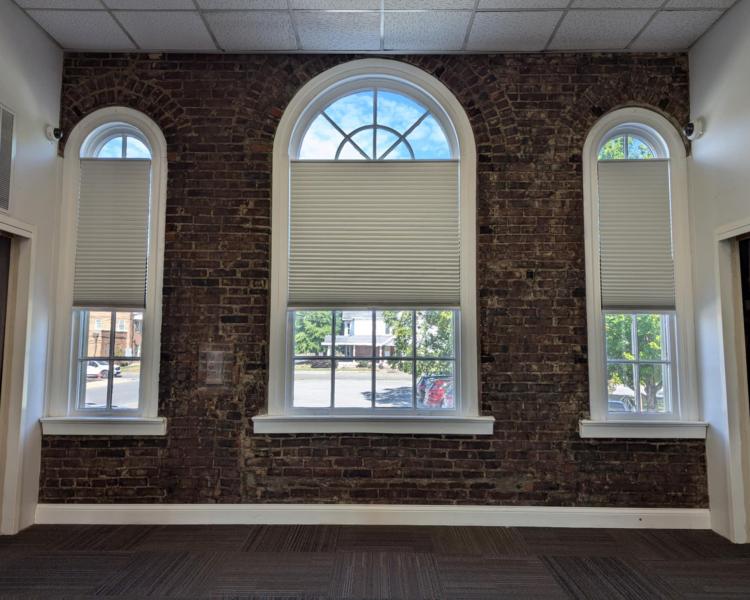 Photo of three arched windows from inside the Auditorium room